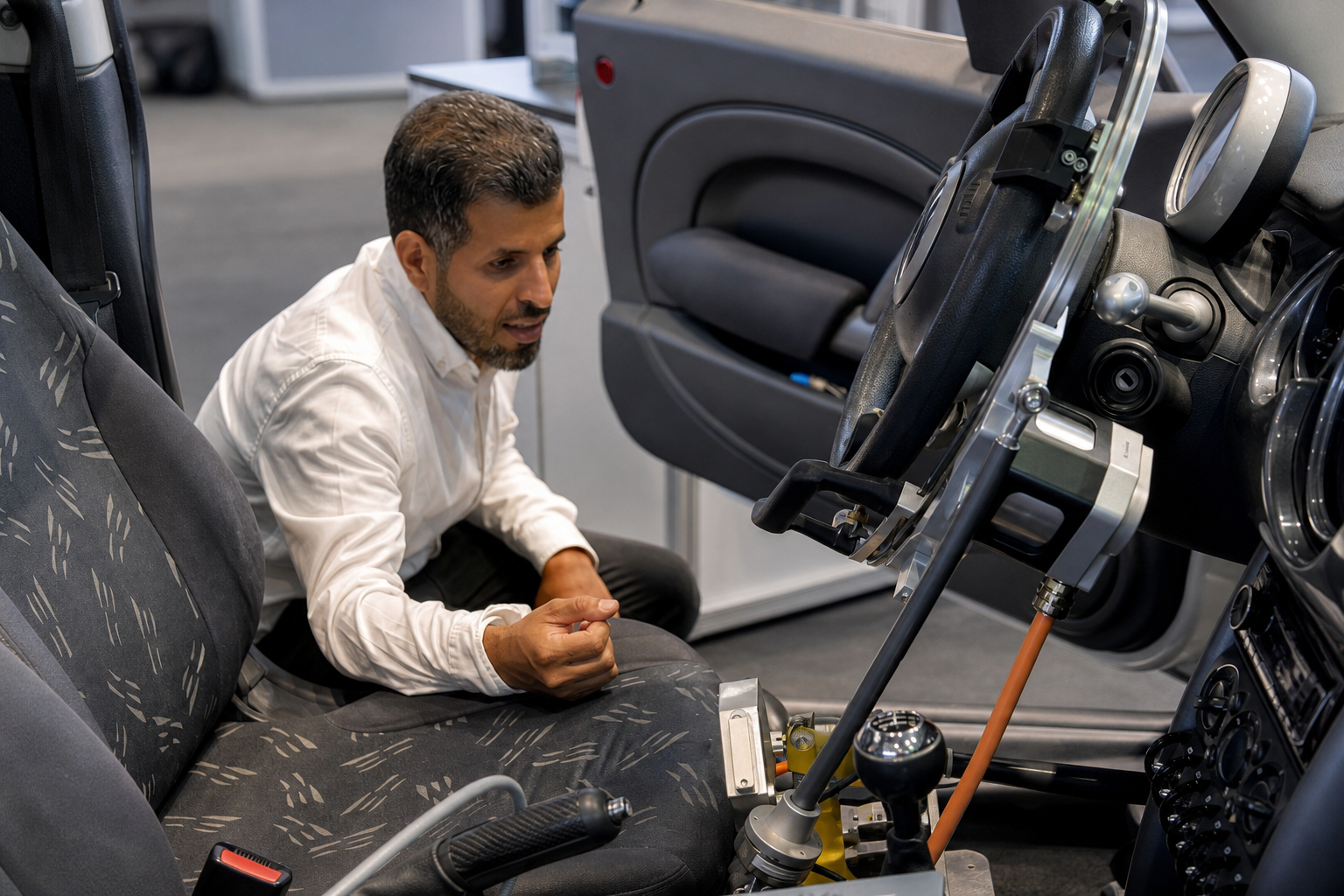 Muaadh Abo-Alrejal examining an in-vehicle engineering test setup